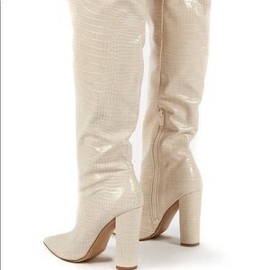 Nude croc print knee high boots with a block heel.